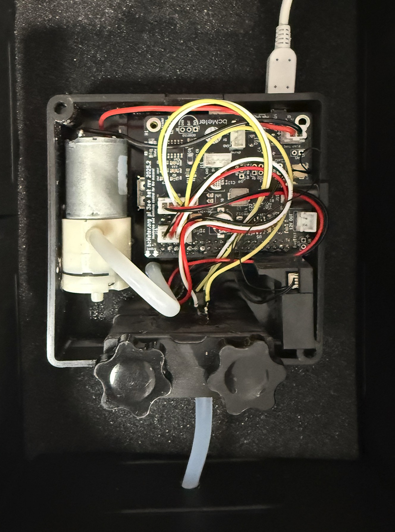 Picture of bcMeter in rugged case with hose from device through the rugged case wall