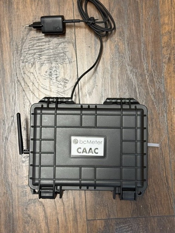 Closed rugged case with antenna, inlet tube, and power cable routed